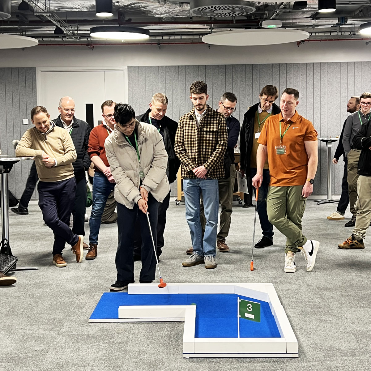Plant Plan Mini Golf - Workplace Putt-Off Event Plant Plan team playing portable mini golf in their office